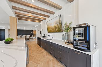 A modern kitchen with dark wood cabinets and a white countertop.